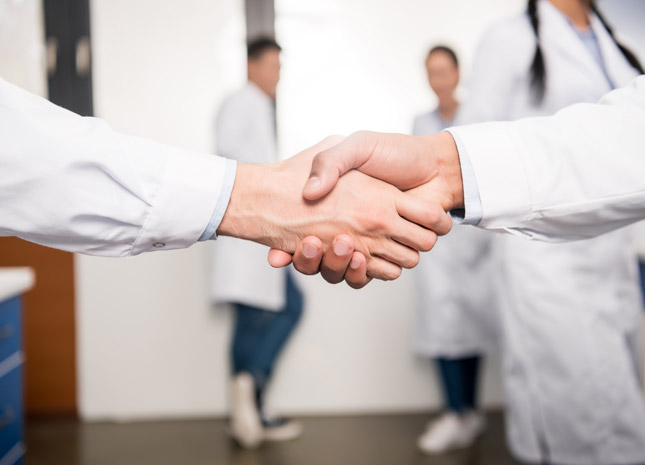Two doctors shaking hands
